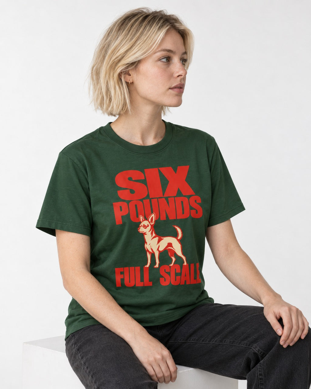 Chihuahua Six Pounds Full Scale Typographic Graphic T-Shirt in Forest Green, worn by a seated model