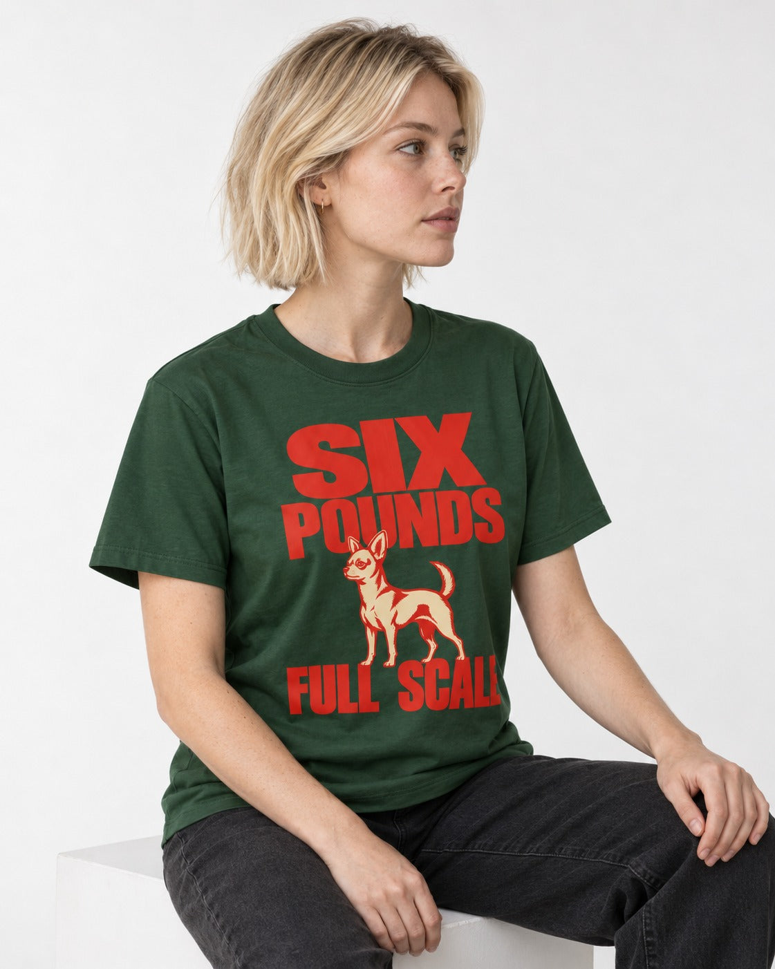 Chihuahua Six Pounds Full Scale Typographic Graphic T-Shirt in Forest Green, worn by a seated model