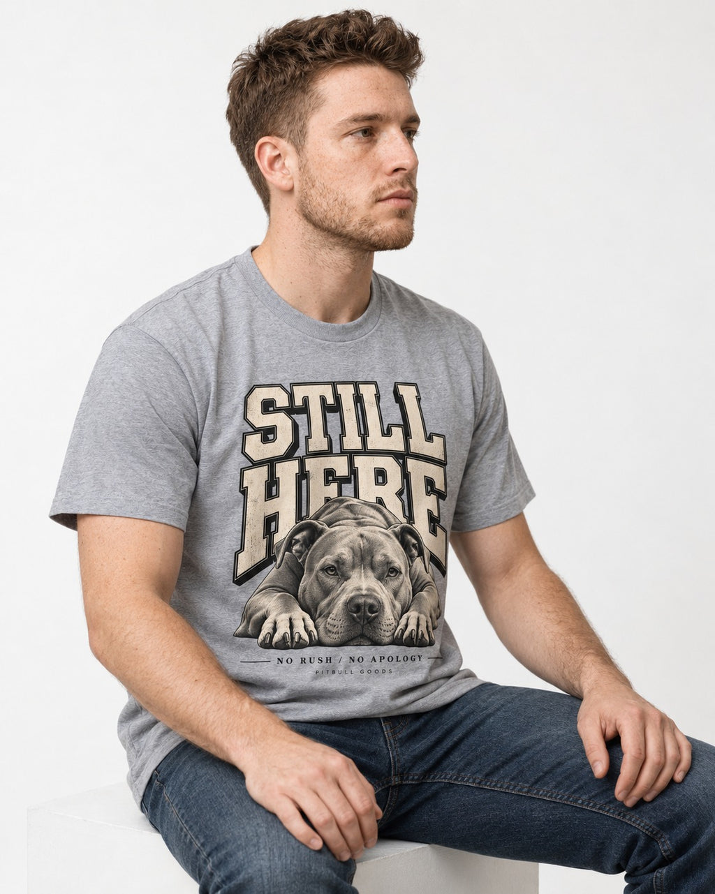 Still Here Pitbull T-Shirt in Sport Grey, worn by a seated model