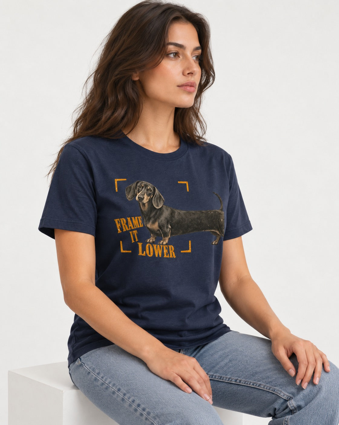 Dachshund Frame It Lower Viewfinder Graphic T-Shirt in Navy, worn by a seated model