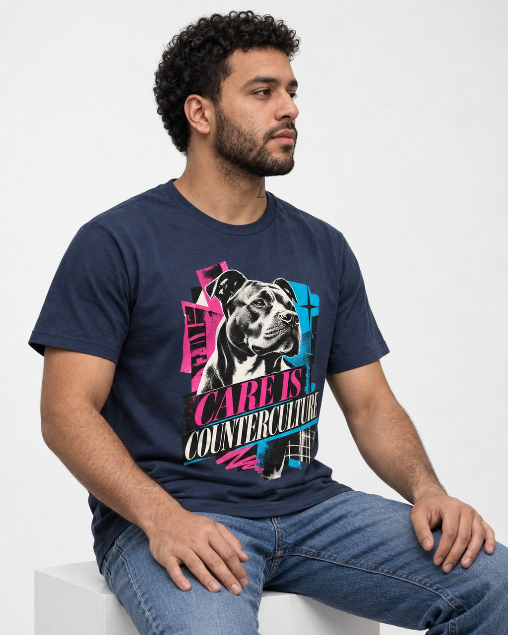 Pitbull Care Is Counterculture Neon Collage Portrait Graphic T-Shirt in Navy, worn by a seated model