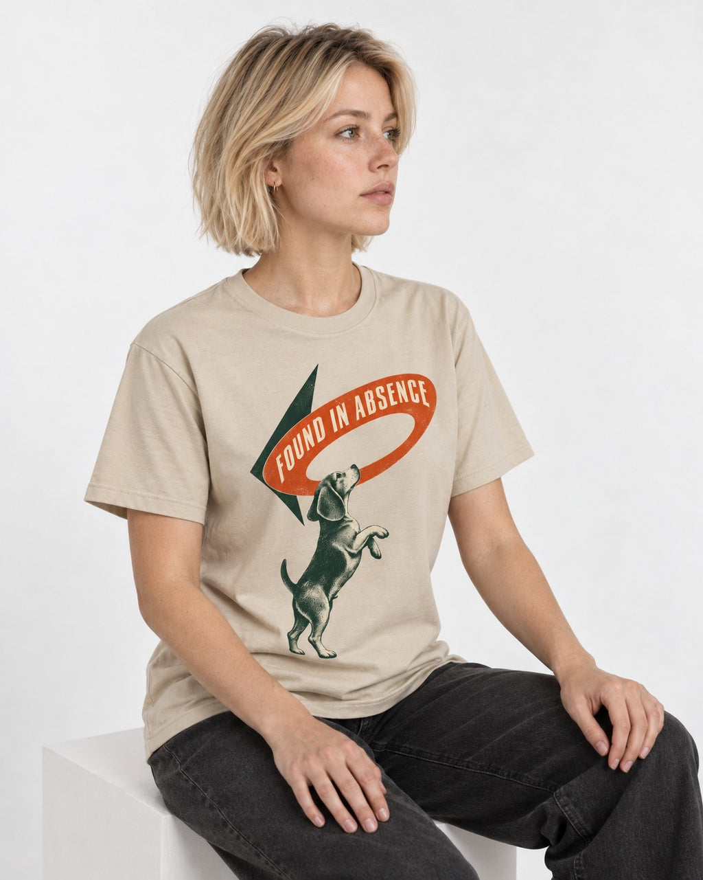 Beagle Found in Absence T-Shirt in Sand, worn by a seated model
