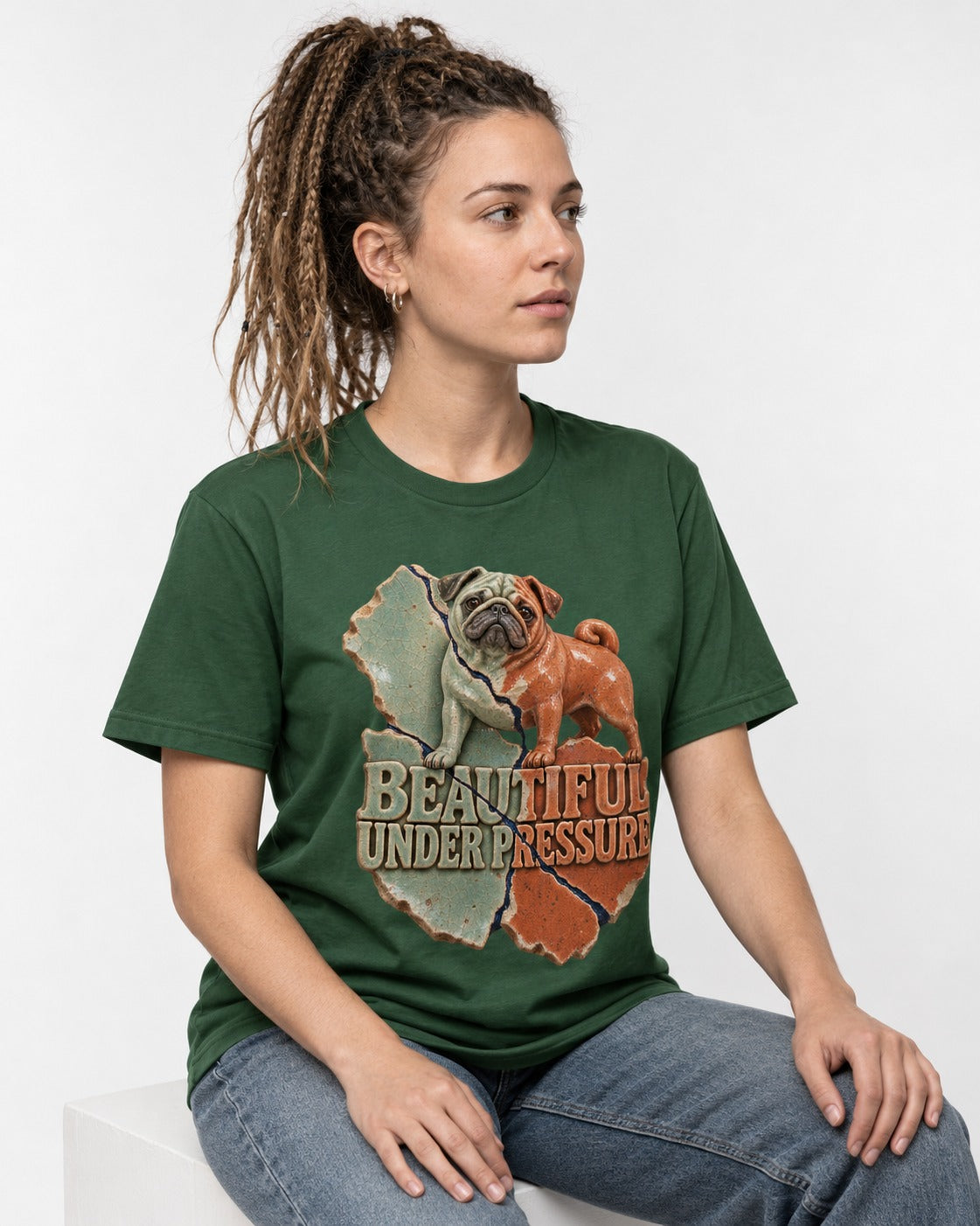 Pug Beautiful Under Pressure Cracked Ceramic Graphic T-Shirt in Forest Green, worn by a seated model