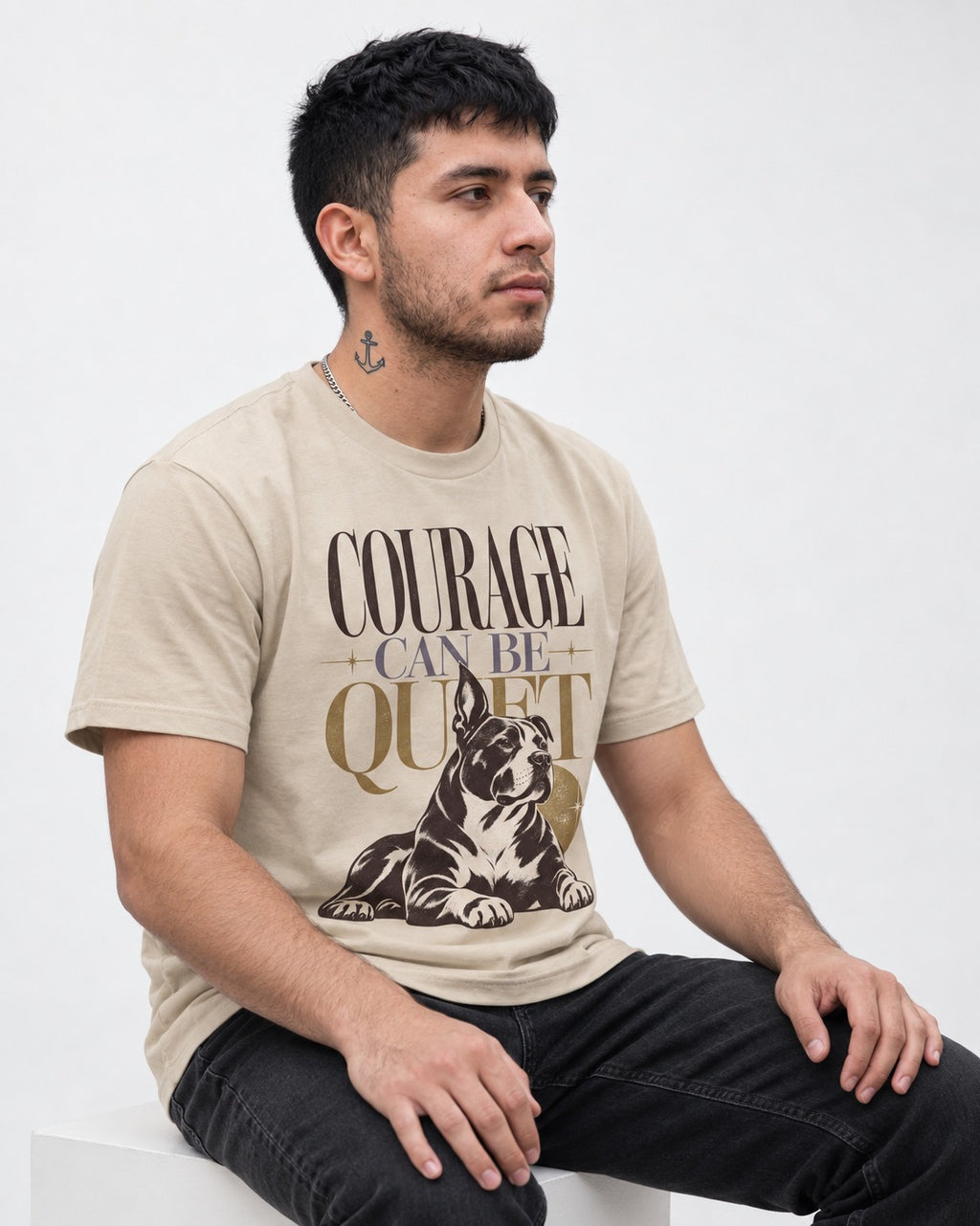 Pitbull Courage Can Be Quiet T-Shirt in Sand, worn by a seated model