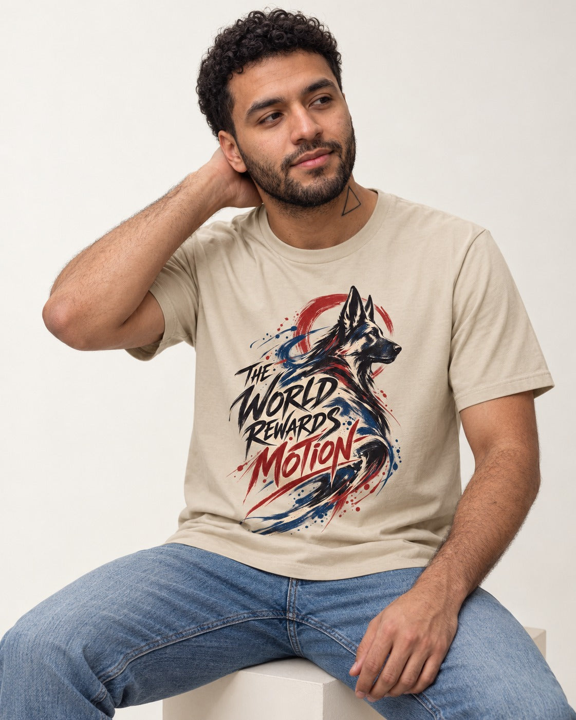 German Shepherd Dog The World Rewards Motion T-Shirt in Sand, worn by a seated model