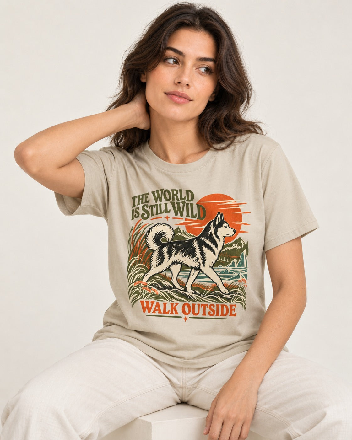 Walk Outside with Husky T-Shirt in Sand, worn by a seated model