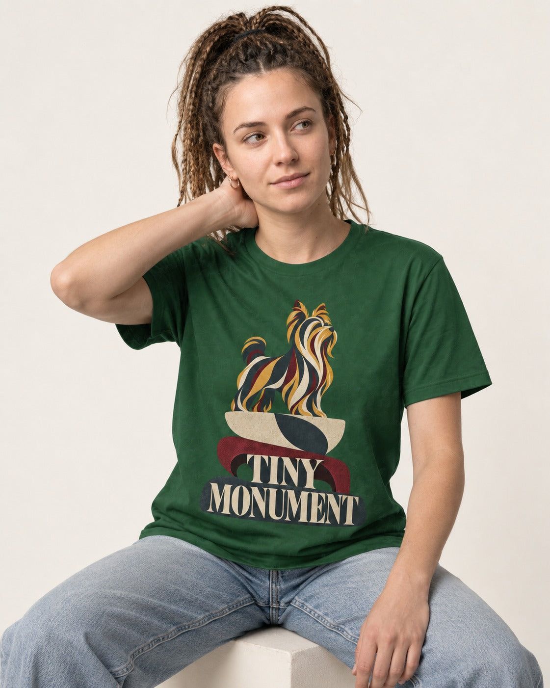 Yorkshire Terrier Tiny Monument Sculptural Plinth Graphic T-Shirt in Forest Green, worn by a seated model