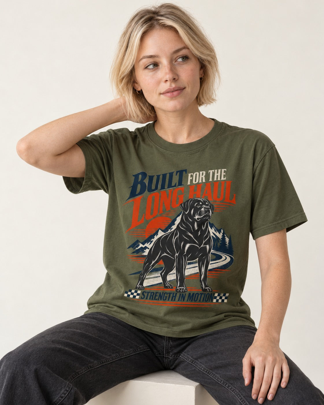 Built for the Long Haul Rottweiler Strength in Motion T-Shirt in Heather Military Green, worn by a seated model