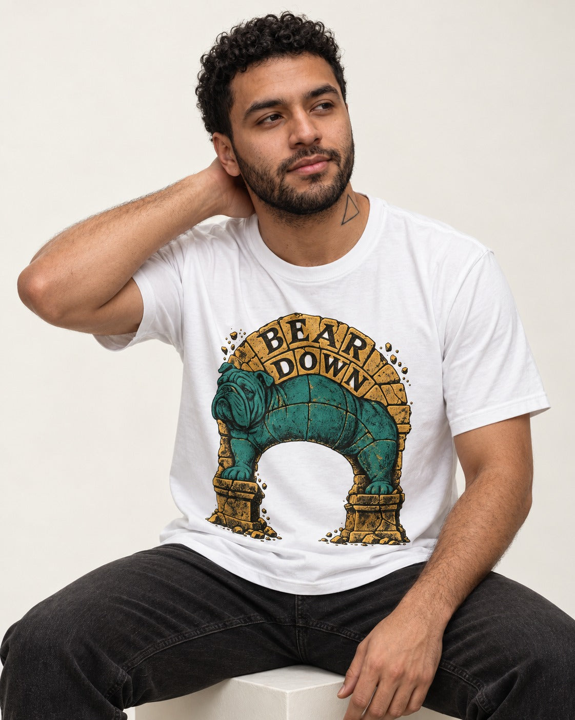 English Bulldog Bear Down Stone Arch Graphic T-Shirt in White, worn by a seated model