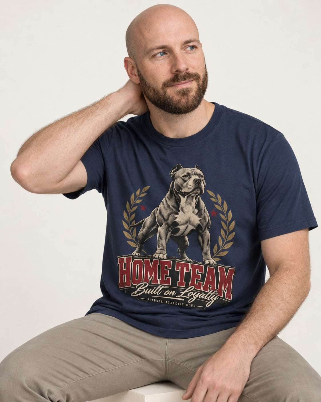 Pitbull Home Team Loyalty Crest Graphic T-Shirt in Navy, worn by a seated model