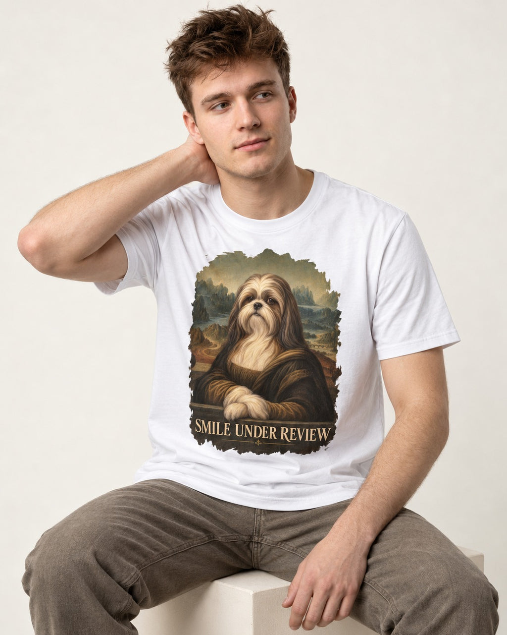 Shih Tzu Smile Under Review Old Master Portrait Graphic T-Shirt in White, worn by a seated model