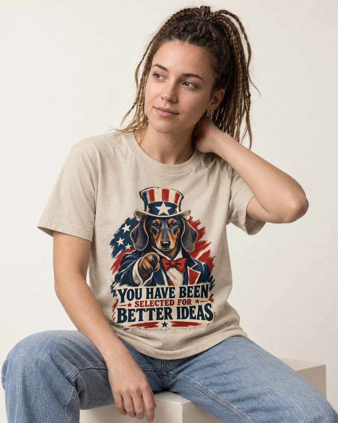 Dachshund Better Ideas T-Shirt in Sand, worn by a seated model