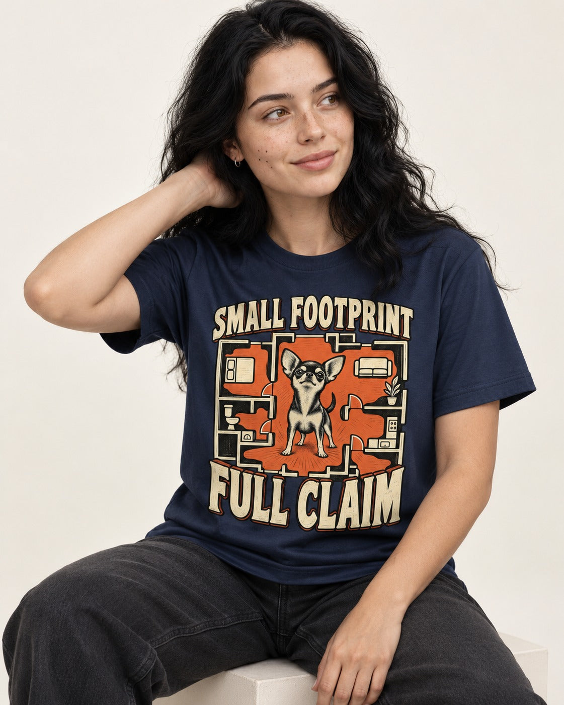 Chihuahua Small Footprint Full Claim Floor Plan Graphic T-Shirt in Navy, worn by a seated model