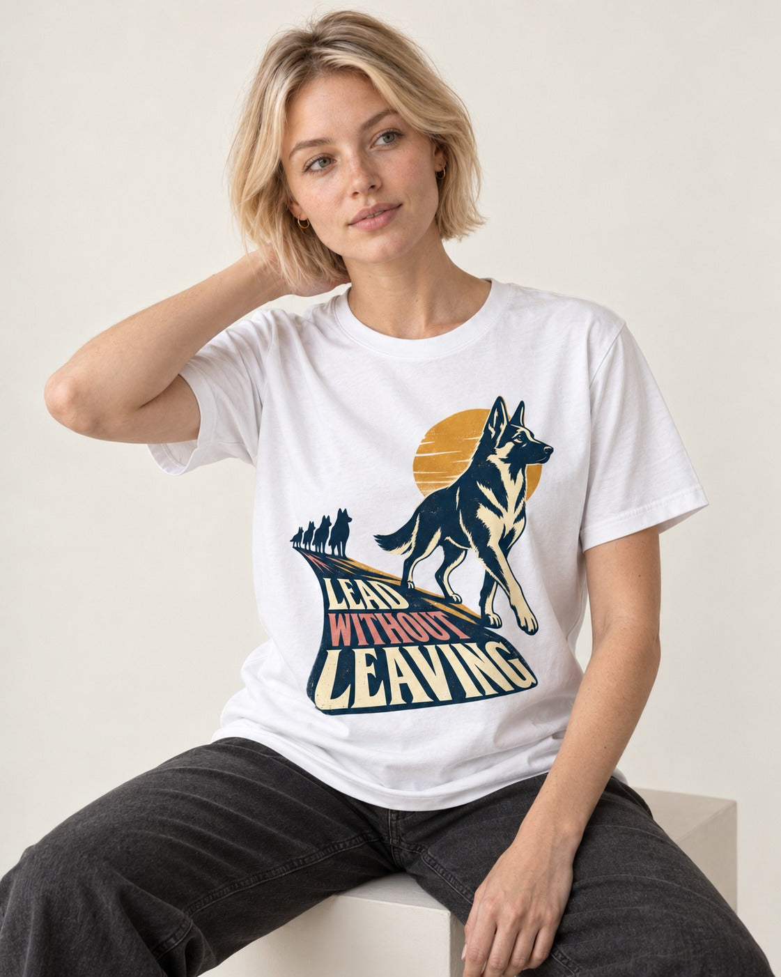 Lead Without Leaving Perspective German Shepherd Dog Graphic T-Shirt in White, worn by a seated model