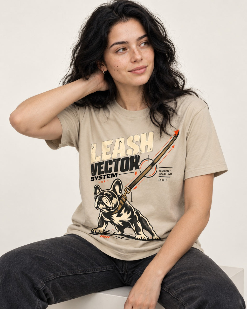 Frenchie Leash Vector T-Shirt in Sand, worn by a seated model