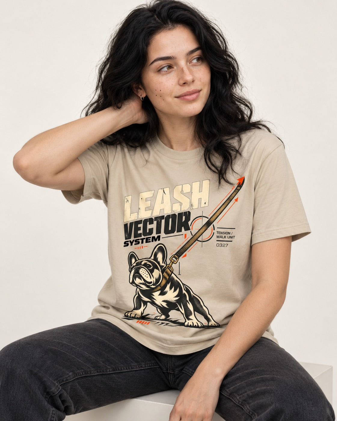 Frenchie Leash Vector T-Shirt in Sand, worn by a seated model