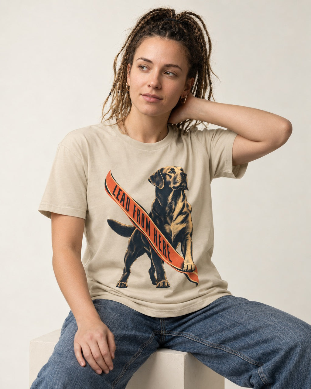 Lead From Here Labrador Retriever T-Shirt in Sand, worn by a seated model