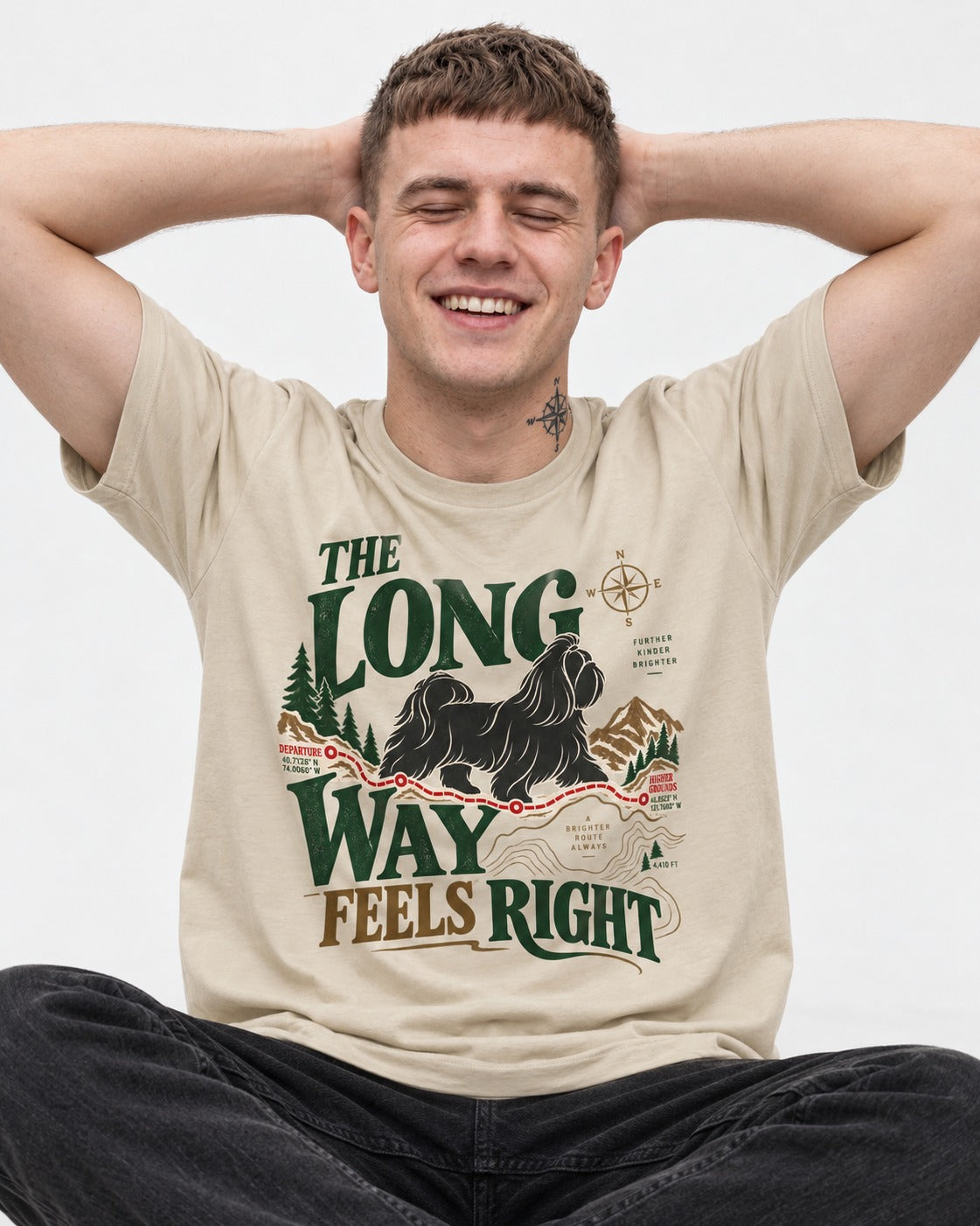 Shih Tzu Takes the Long Way T-Shirt in Sand, worn by a seated model