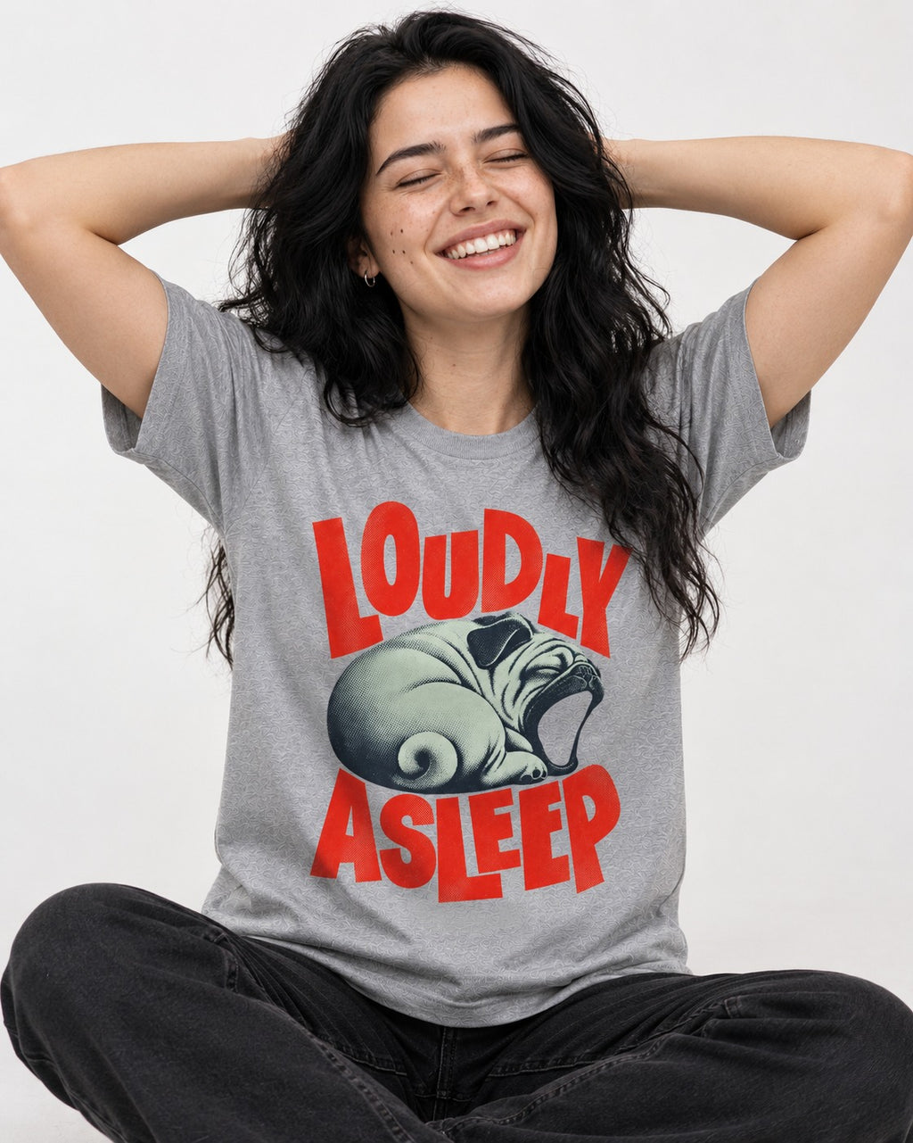 Pug Loudly Asleep Curled Yawn Graphic T-Shirt in Sport Grey, worn by a seated model