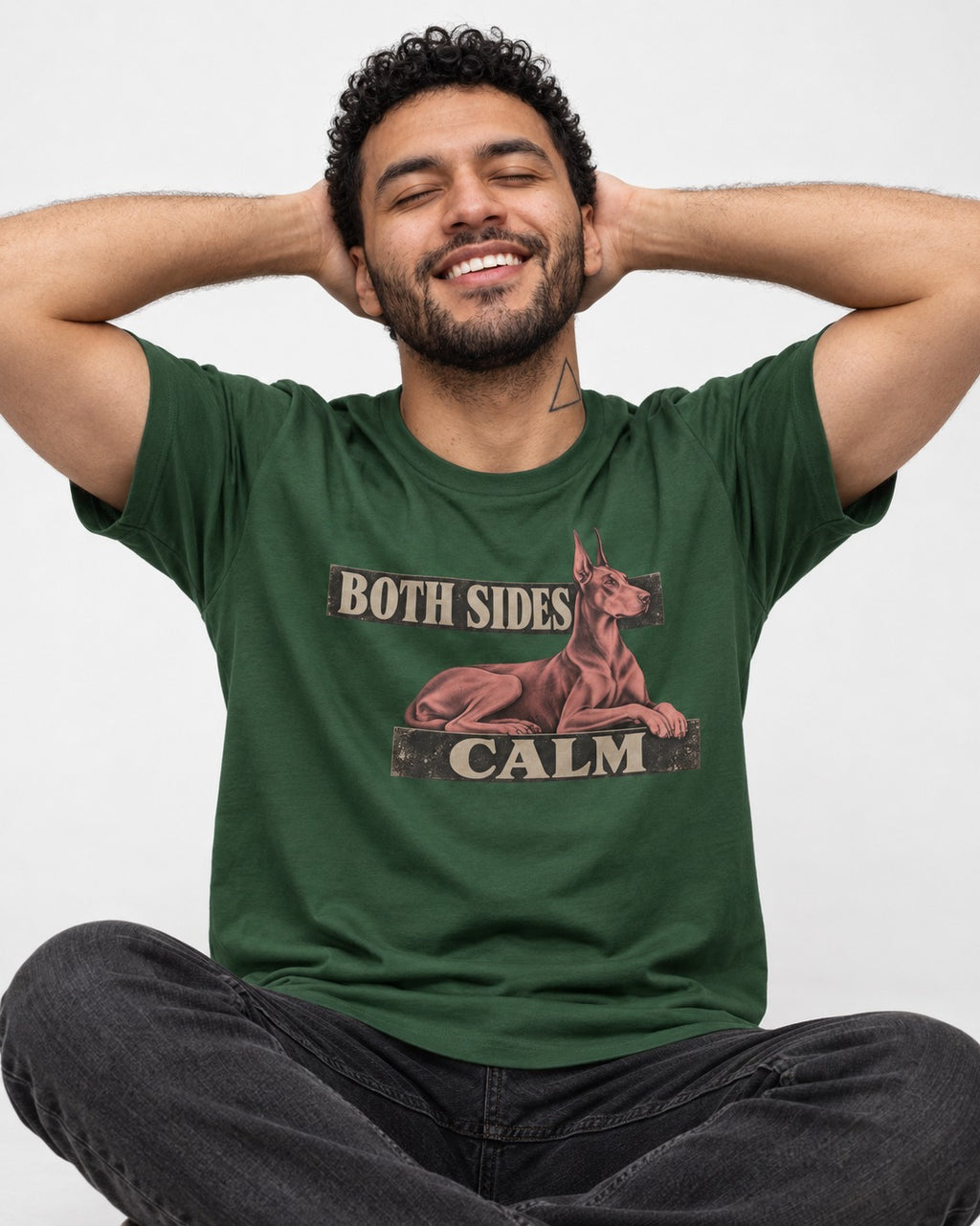 Doberman Both Sides Calm Banner T-Shirt in Forest Green, worn by a seated model
