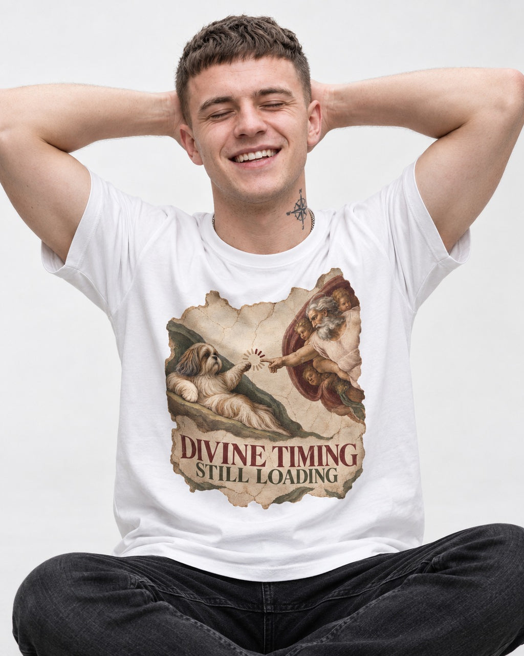 Shih Tzu Divine Timing Still Loading Renaissance Parody Graphic T-Shirt in White, worn by a seated model