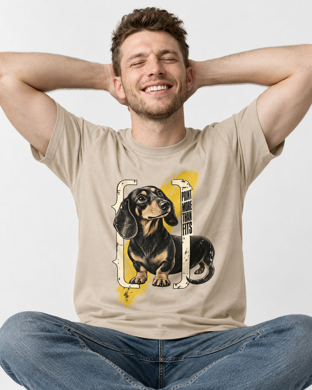 Dachshund More Than Fits T-Shirt in Sand, worn by a seated model
