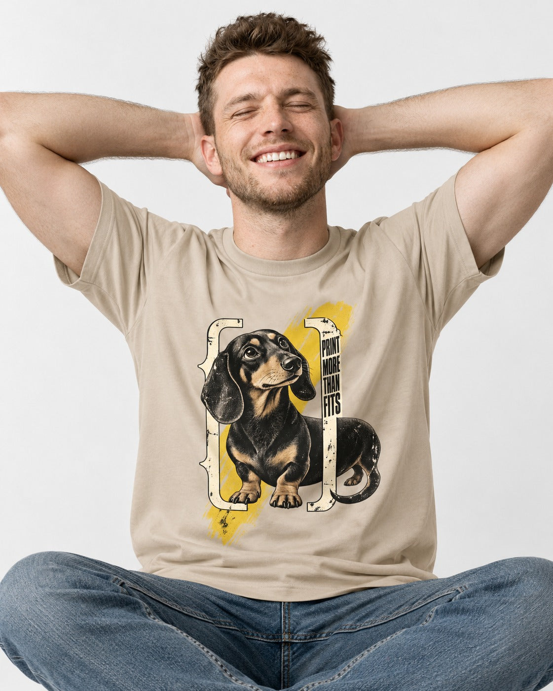 Dachshund More Than Fits T-Shirt in Sand, worn by a seated model