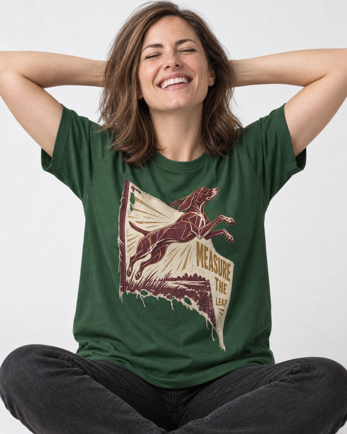 German Shorthaired Pointer Measure the Leap Torn Banner Graphic T-Shirt in Forest Green, worn by a seated model
