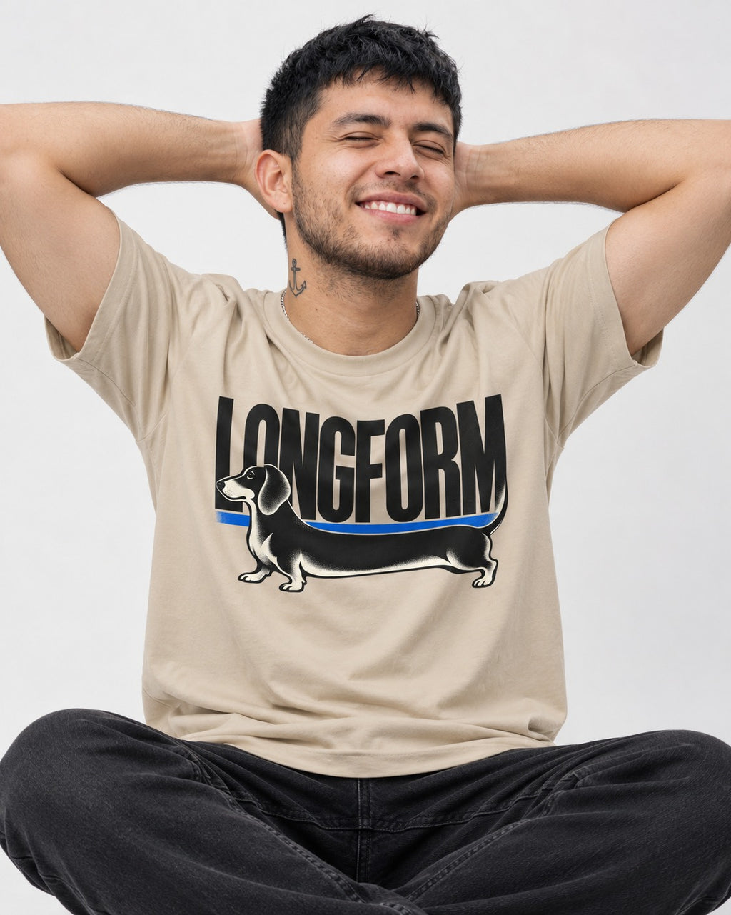 Longform Dachshund T-Shirt in Sand, worn by a seated model