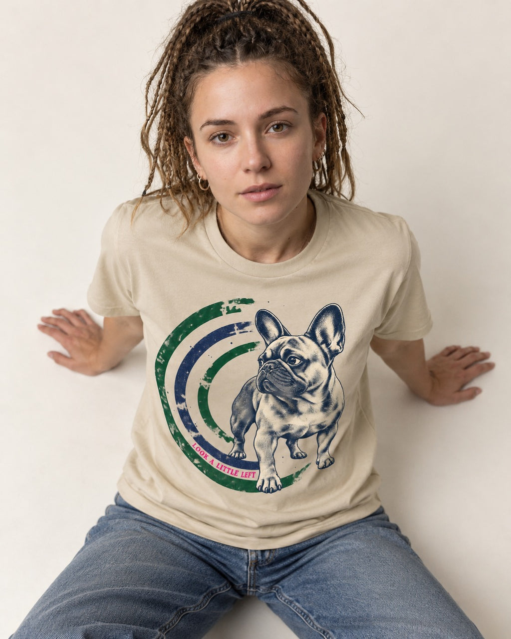 Frenchie Look a Little Left Orbit Graphic T-Shirt in Sand, worn by a seated model