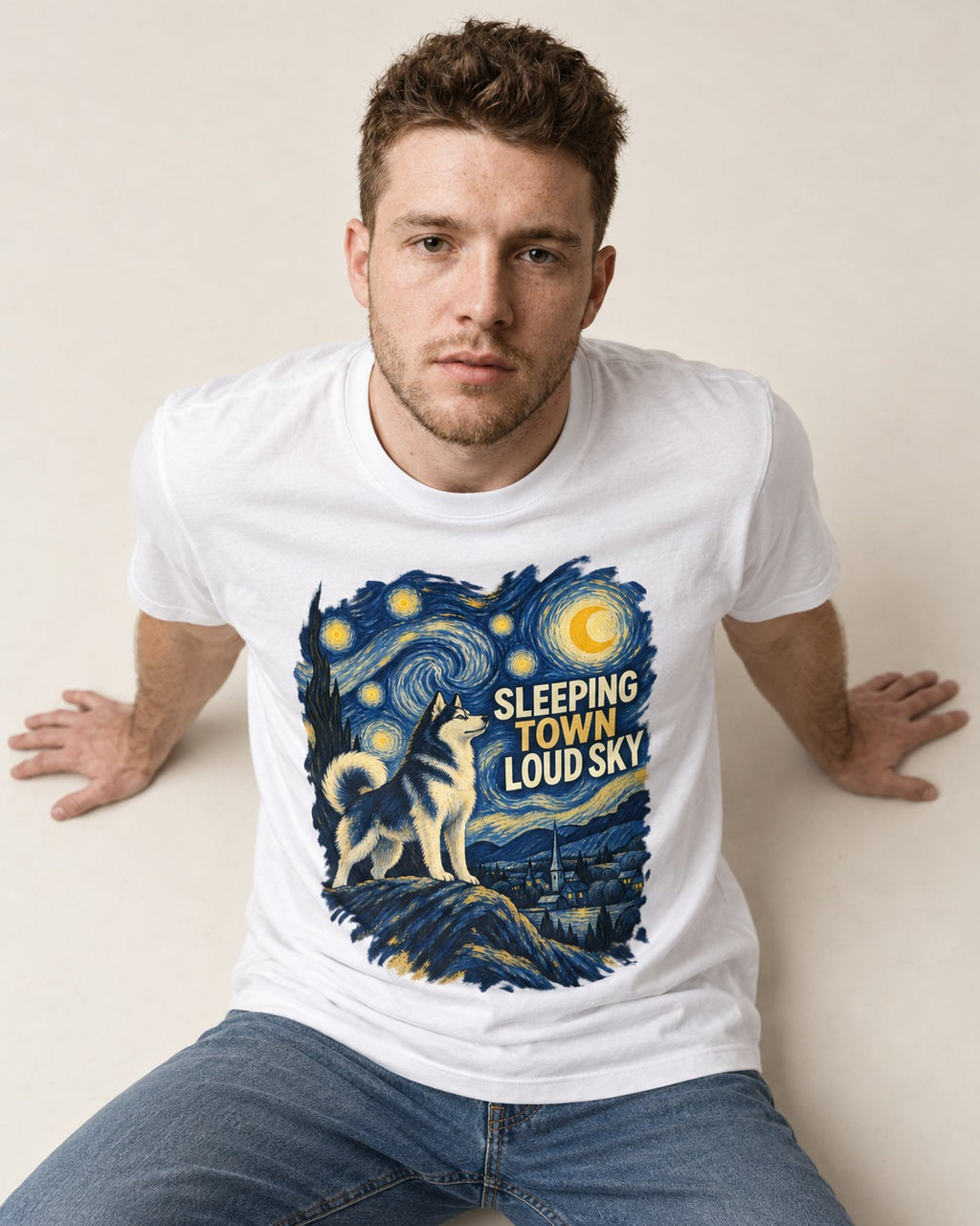 Husky Sleeping Town Loud Sky Starry Night Graphic T-Shirt in White, worn by a seated model