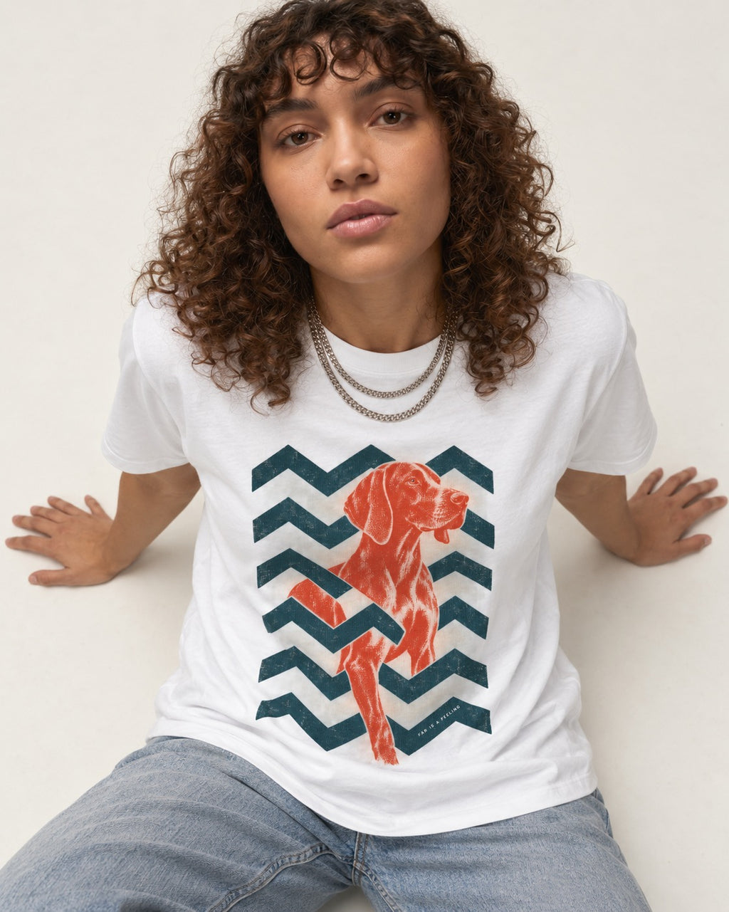 German Shorthaired Pointer Far Is a Feeling Chevron Graphic T-Shirt in White, worn by a seated model