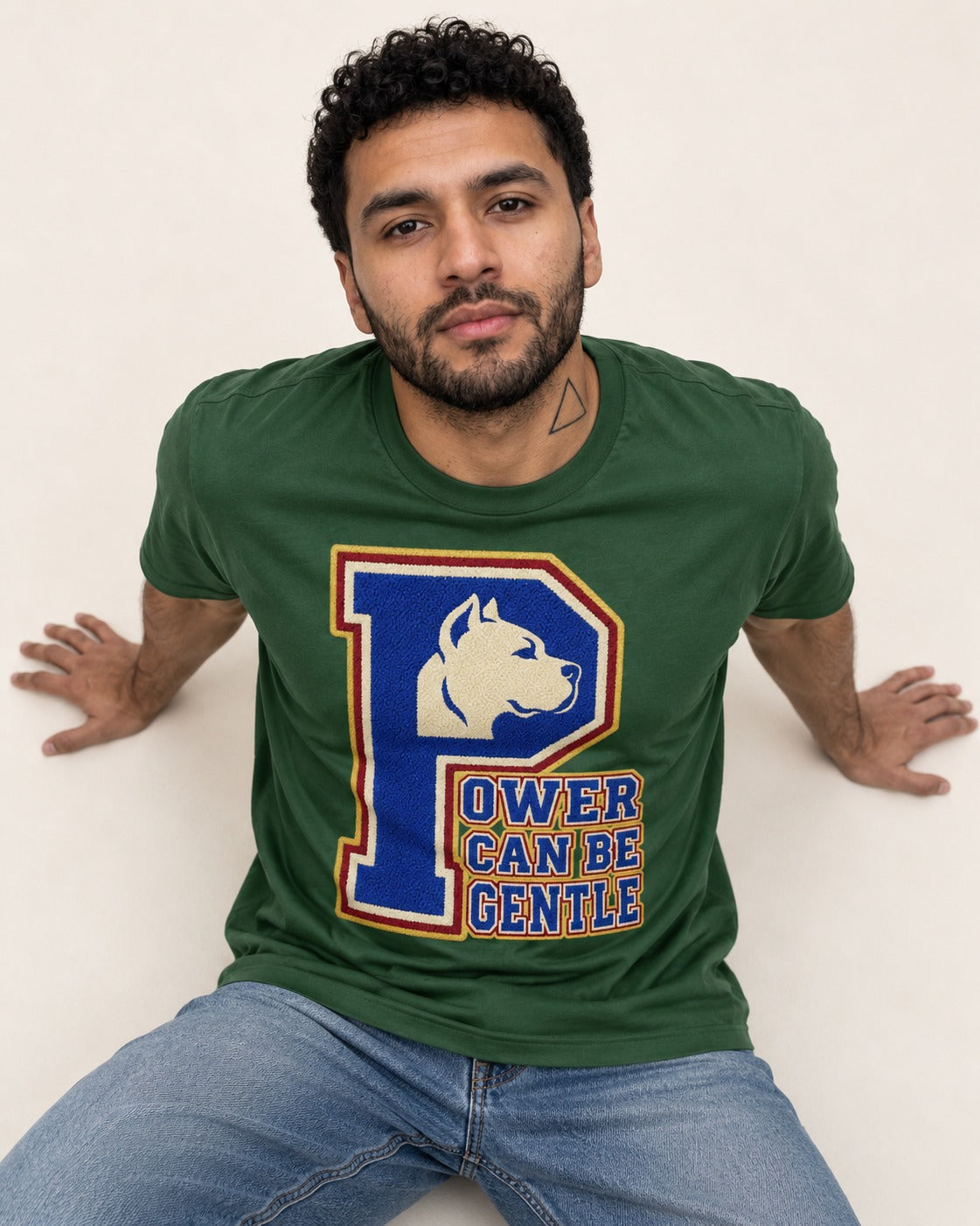 Pitbull Power Can Be Gentle Varsity Graphic T-Shirt in Forest Green, worn by a seated model