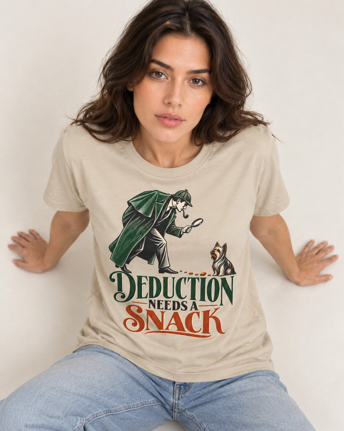 Yorkshire Terrier Needs a Snack T-Shirt in Sand, worn by a seated model