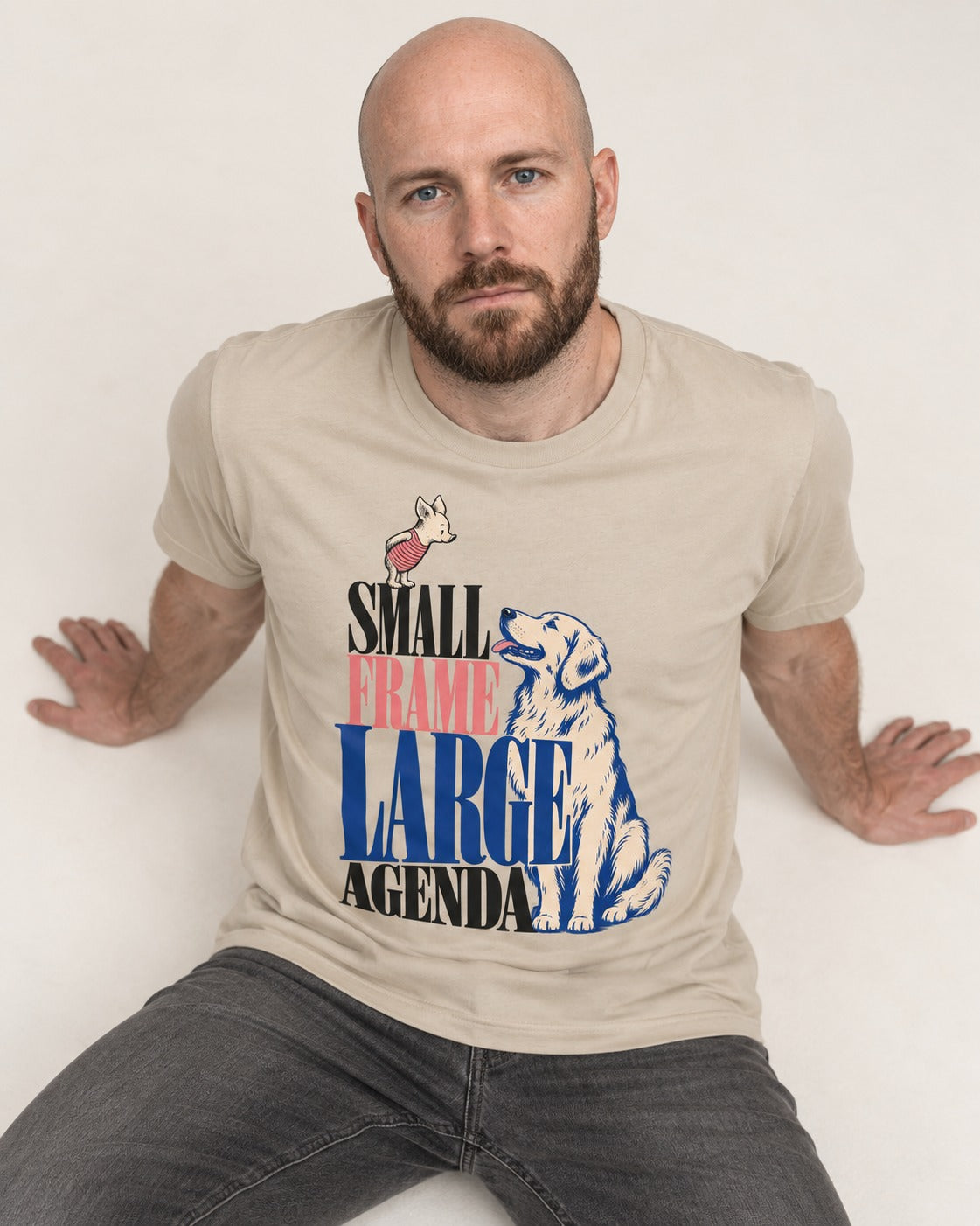 Small Frame Large Agenda Golden Retriever T-Shirt in Sand, worn by a seated model