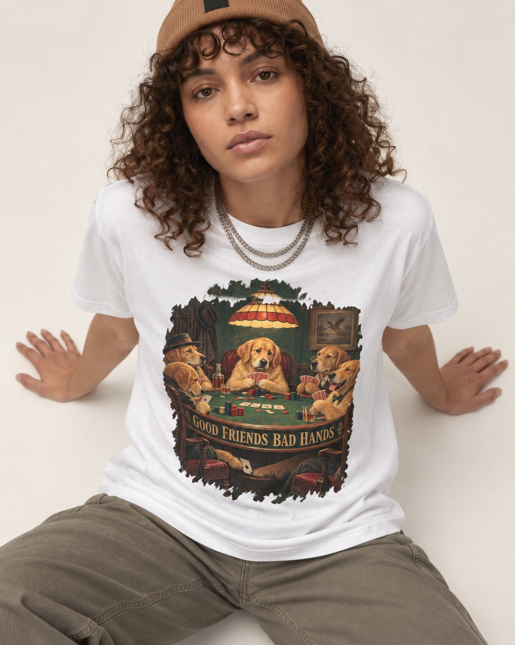 Good Friends Bad Hands Poker Golden Retriever Graphic T-Shirt in White, worn by a seated model