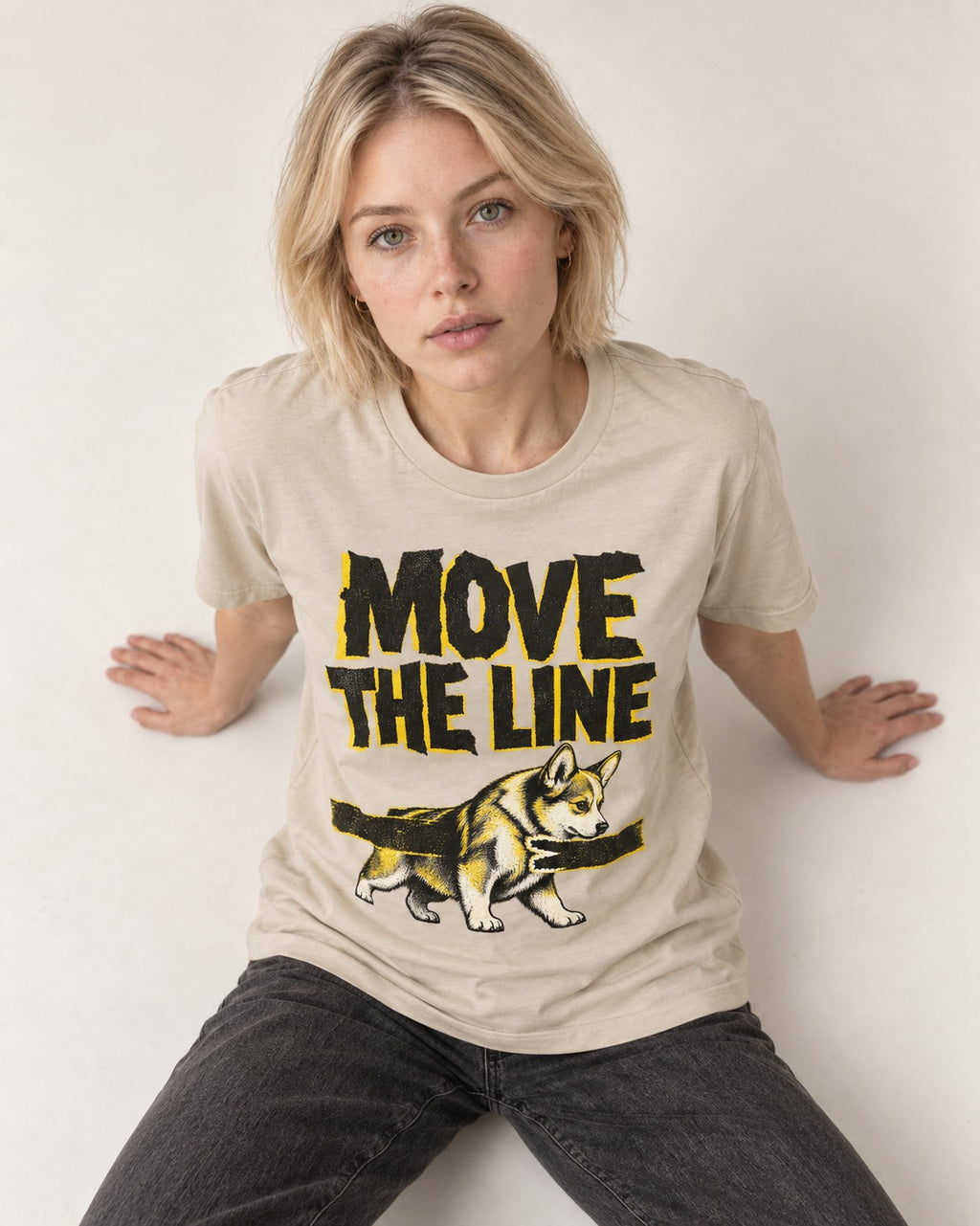 Corgi Move the Line T-Shirt in Sand, worn by a seated model