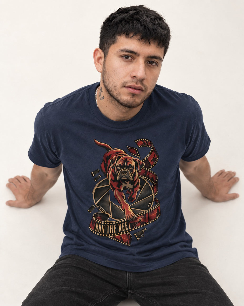 Run the Reel Boxer Film Graphic T-Shirt in Navy, worn by a seated model