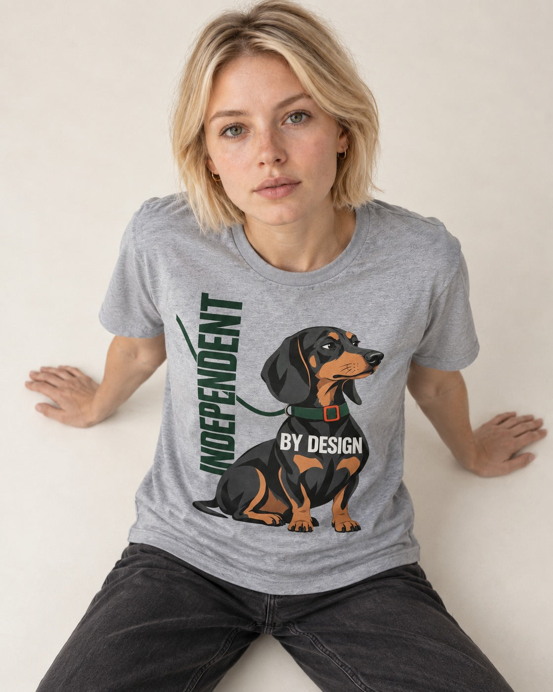 Independent Dachshund T-Shirt in Sport Grey, worn by a seated model