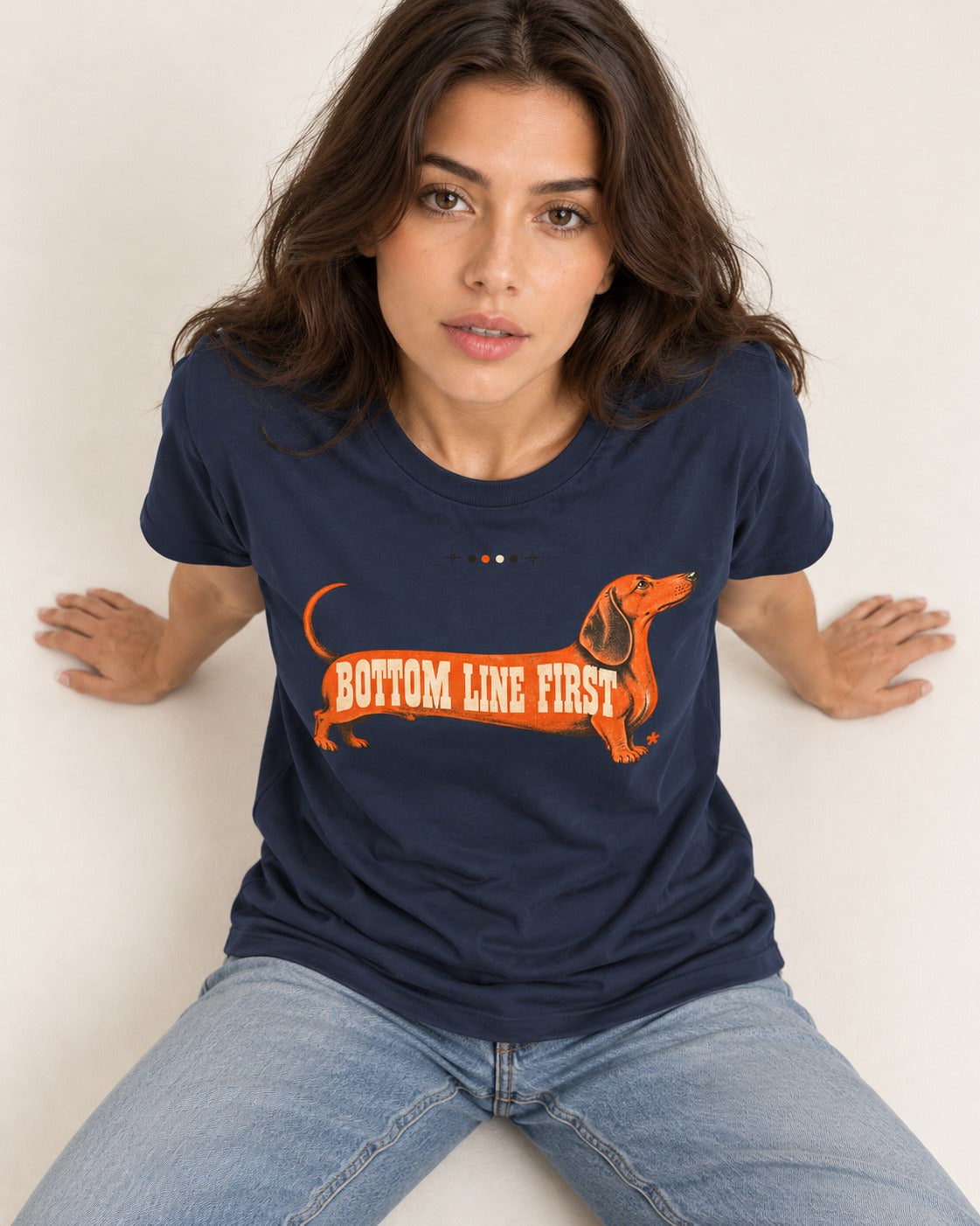 Dachshund Bottom Line First Body Lettering Graphic T-Shirt in Navy, worn by a seated model