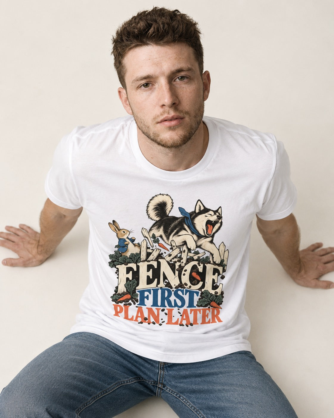 Husky Fence First Plan Later Garden Escape Graphic T-Shirt in White, worn by a seated model