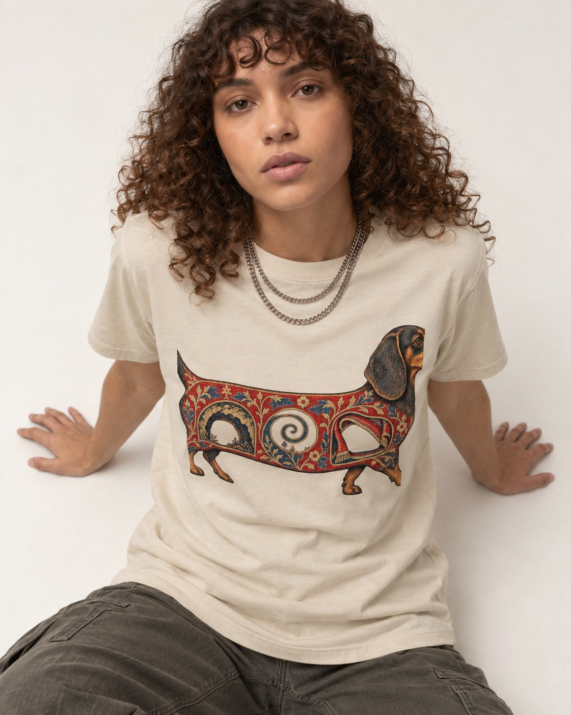 Dachshund Ever After T-Shirt in Sand, worn by a seated model