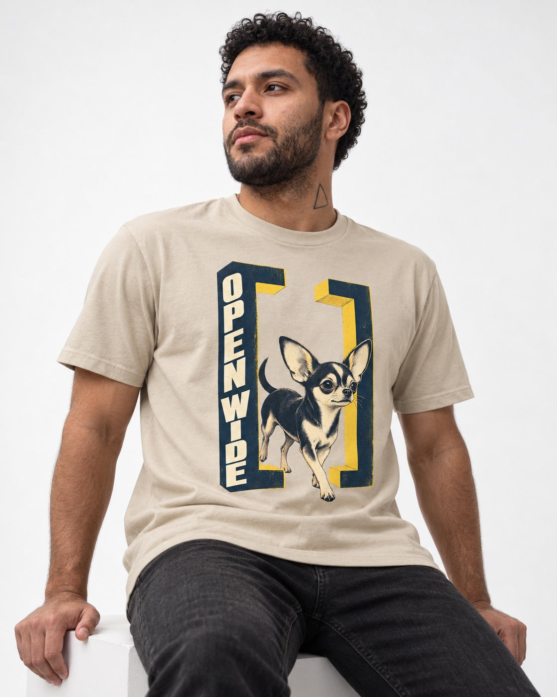 Open Wide Chihuahua T-Shirt in Sand, worn by a seated model