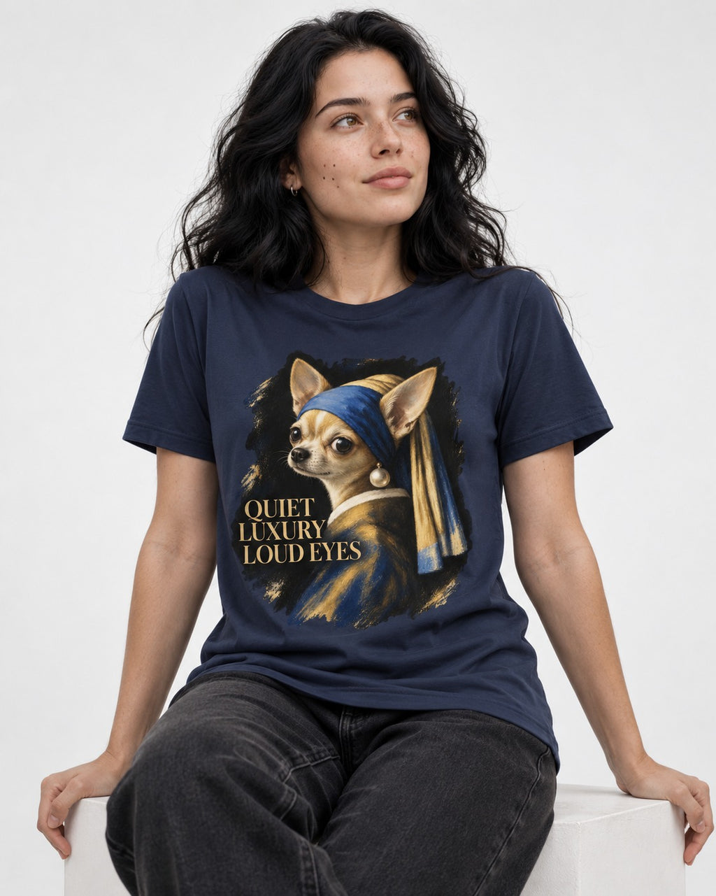 Chihuahua Quiet Luxury Loud Eyes Pearl Earring Portrait T-Shirt in Navy, worn by a seated model