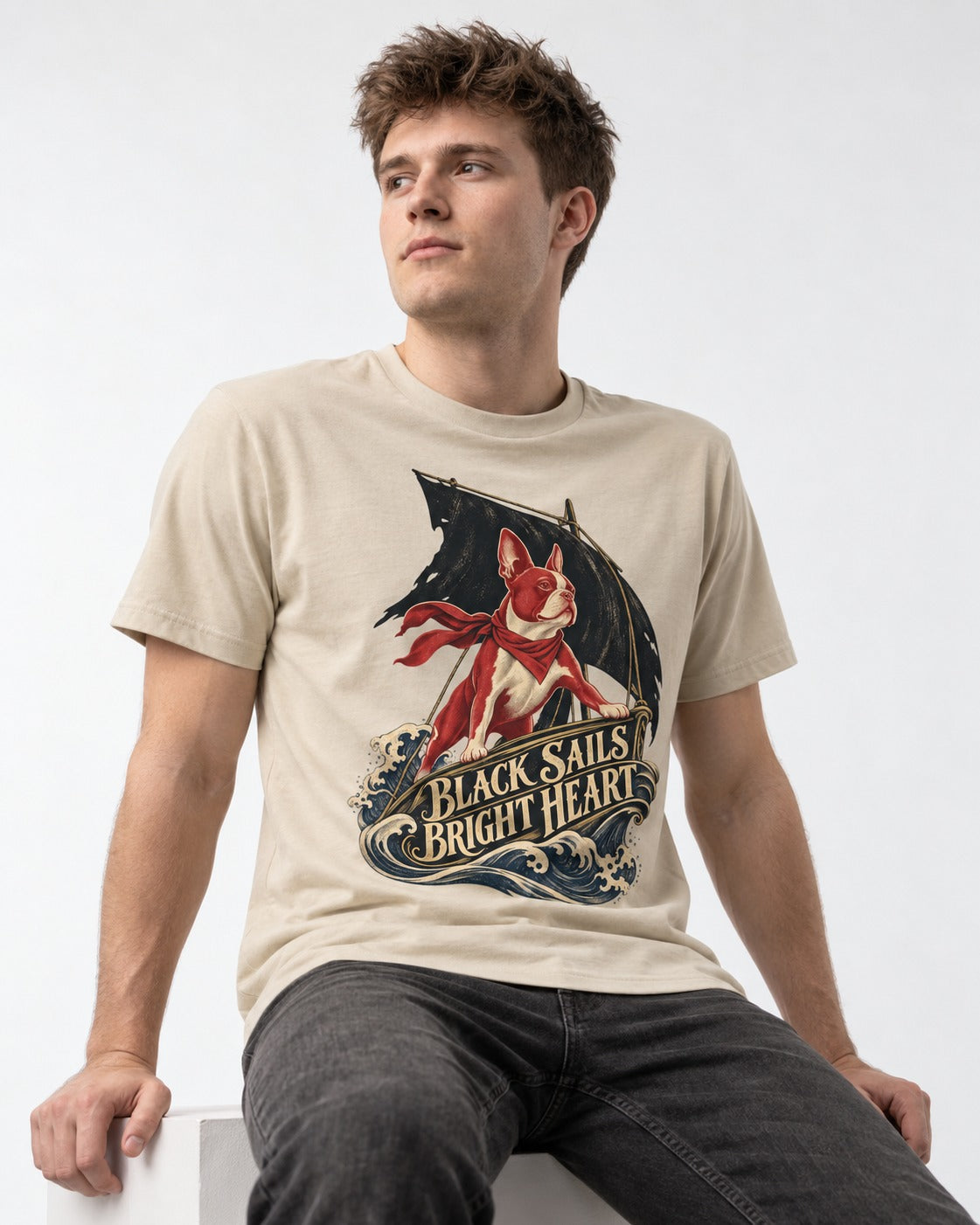 Black Sails Bright Heart Boston Terrier T-Shirt in Sand, worn by a seated model