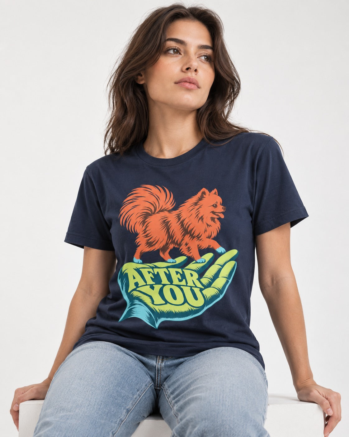 Pomeranian After You Helping Hand Graphic T-Shirt in Navy, worn by a seated model
