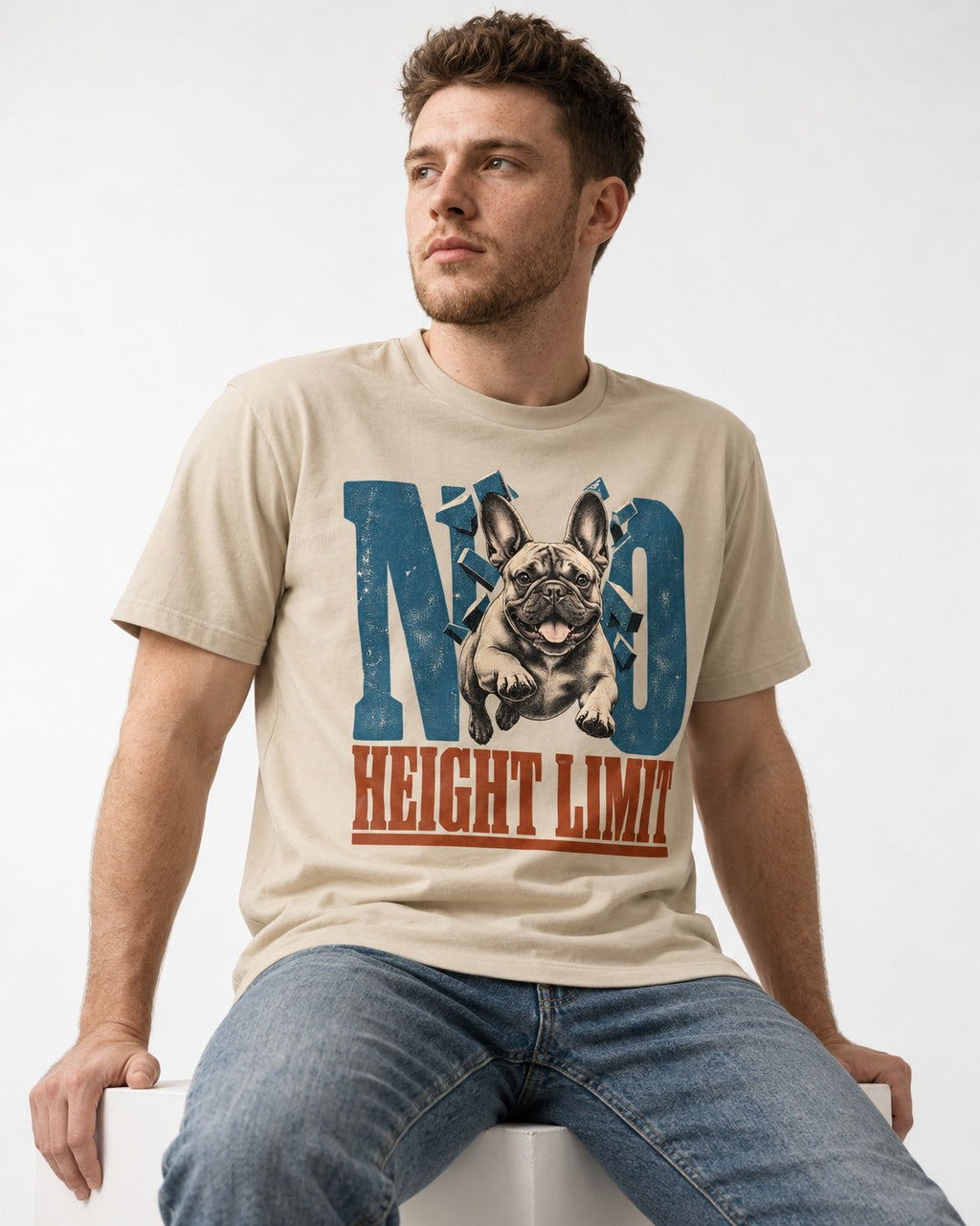 No Height Limit Frenchie T-Shirt in Sand, worn by a seated model