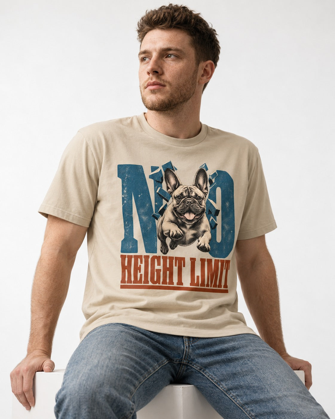 No Height Limit Frenchie T-Shirt in Sand, worn by a seated model