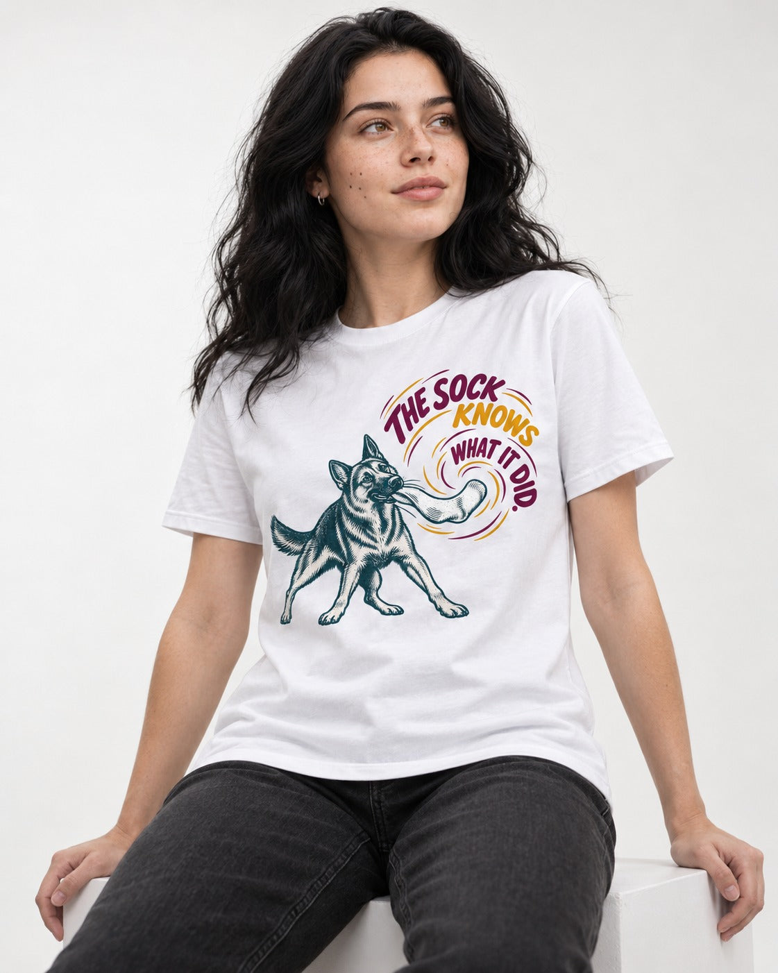 German Shepherd Dog The Sock Knows What I Did Graphic T-Shirt in White, worn by a seated model
