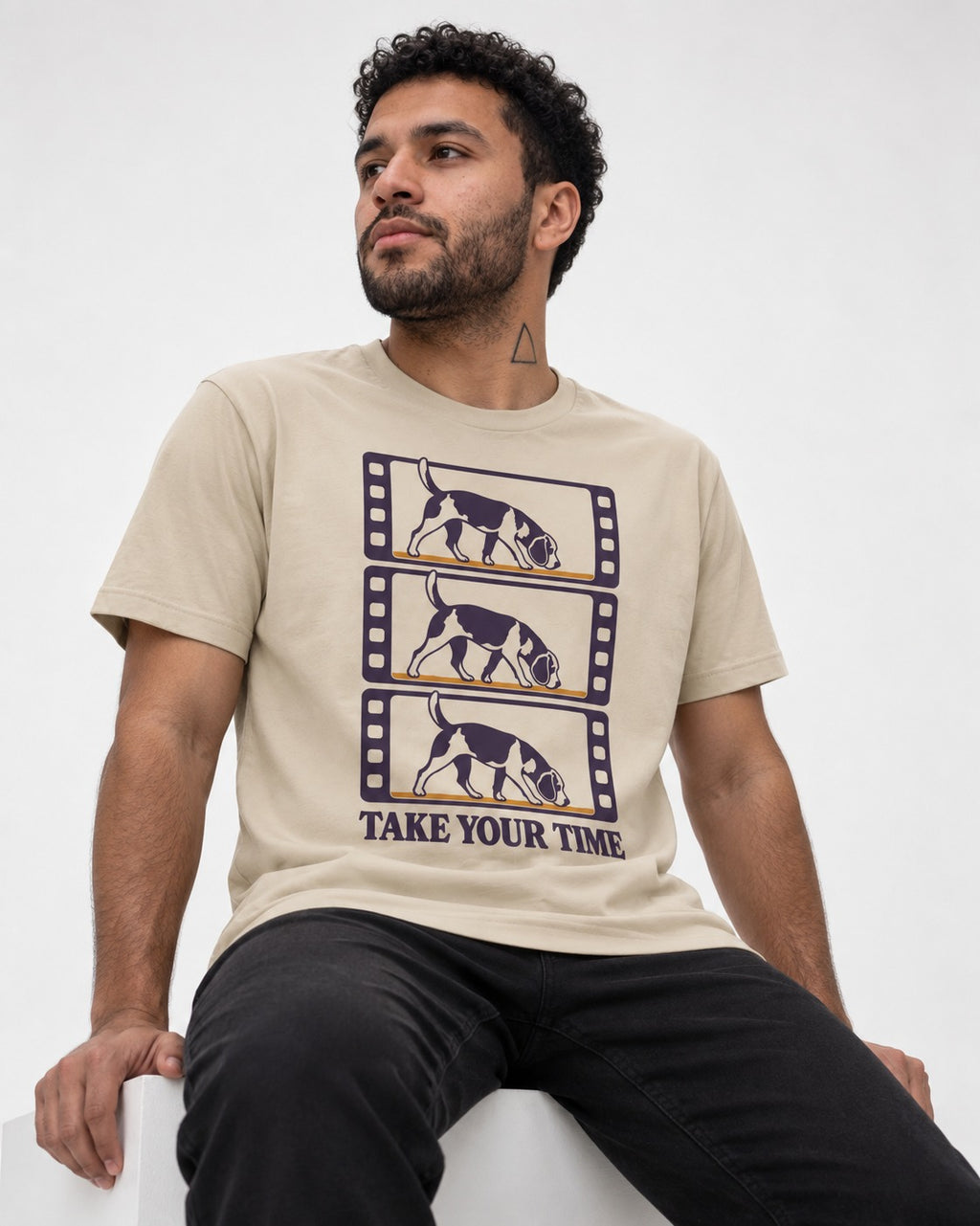 Beagle Take Your Time T-Shirt in Sand, worn by a seated model